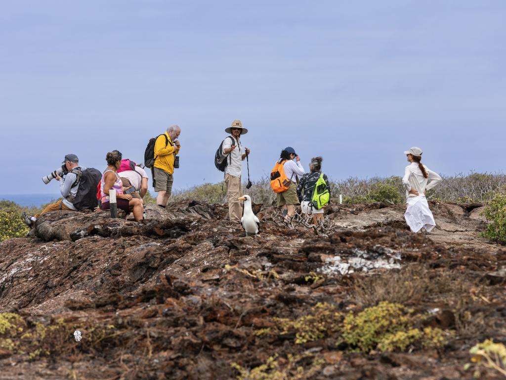 Travelers exploring the volcanic landscapes of San Cristobal Island